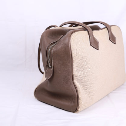 Hermes Victoria 35 Handbag in Taurillon Clemence/Toile Etoupe ,left side view 